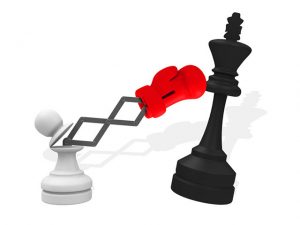 white pawn punching black king chess piece