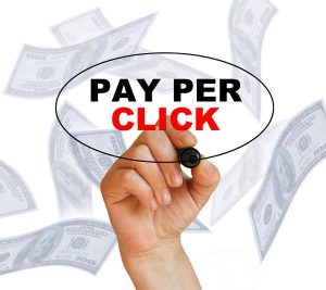 Hand writing the words ' pay per click ' on a white background