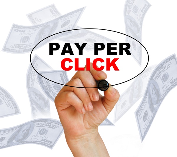 Hand writing the words 'Pay Per Click' on white background