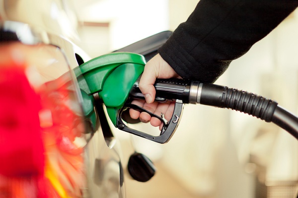Image of person fueling car at a gas station