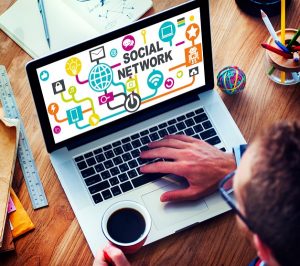 Businessman planning social media strategy on laptop