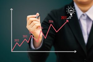 Businessman drawing graph showing growth for the year 2017