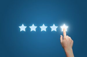 Medical professional pointing to five star to increase