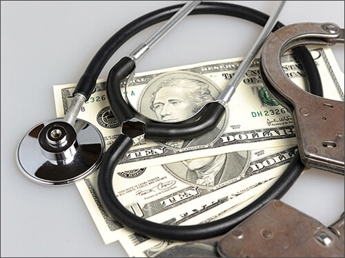 Money with stethoscope and handcuffs