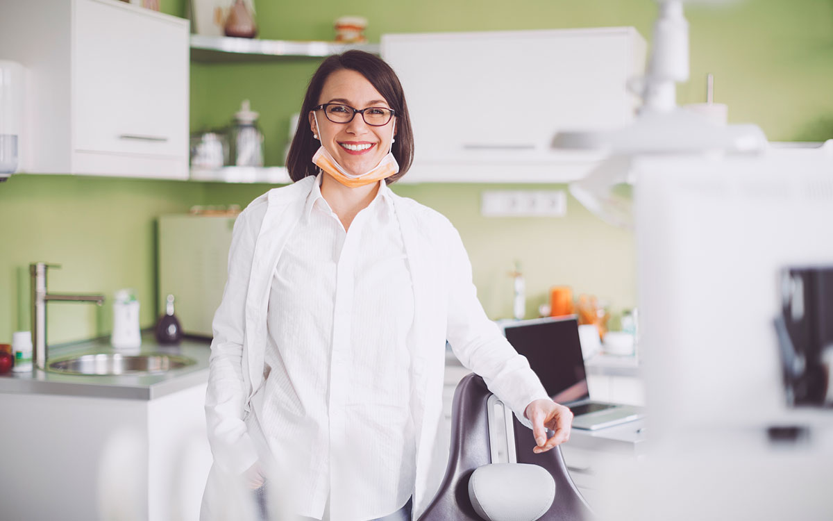 Female orthodontist happy because she got more patients through dental marketing strategies.