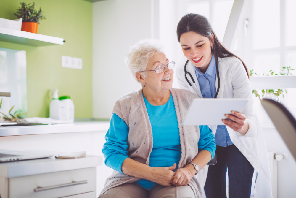 Audiologist and happy patient looking at a website